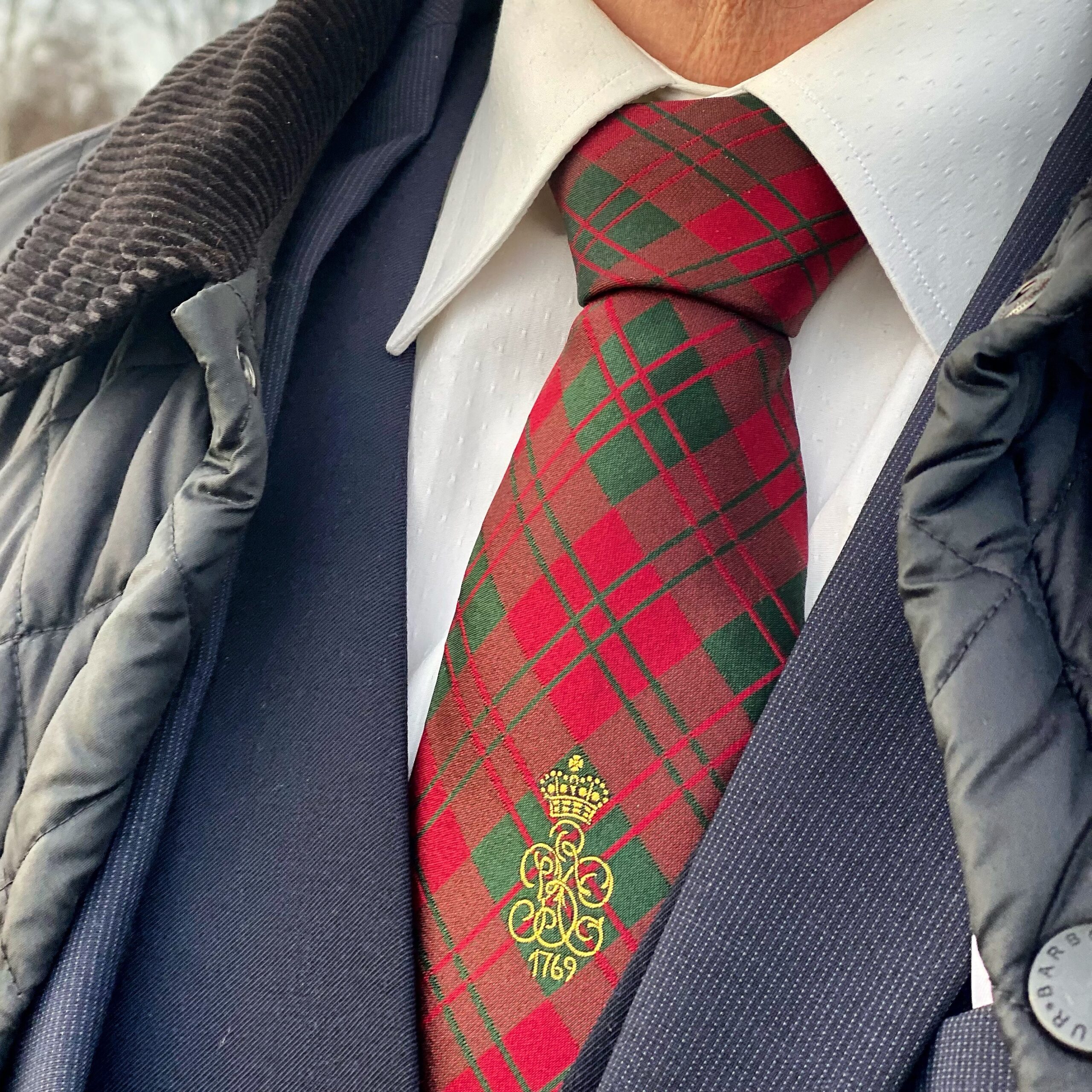 Tartan tie featuring a green and red pattern with a crown emblem and the number 1769.