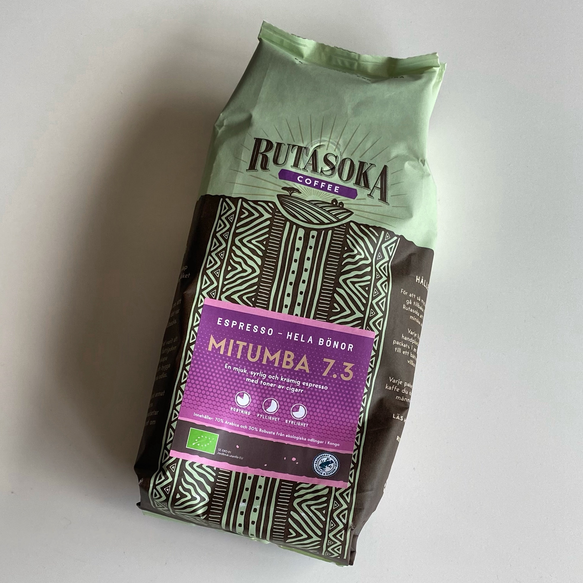 Packaged coffee beans from Rutatsoka Coffee, labelled Mitumba 7.3 with eco-friendly certifications.