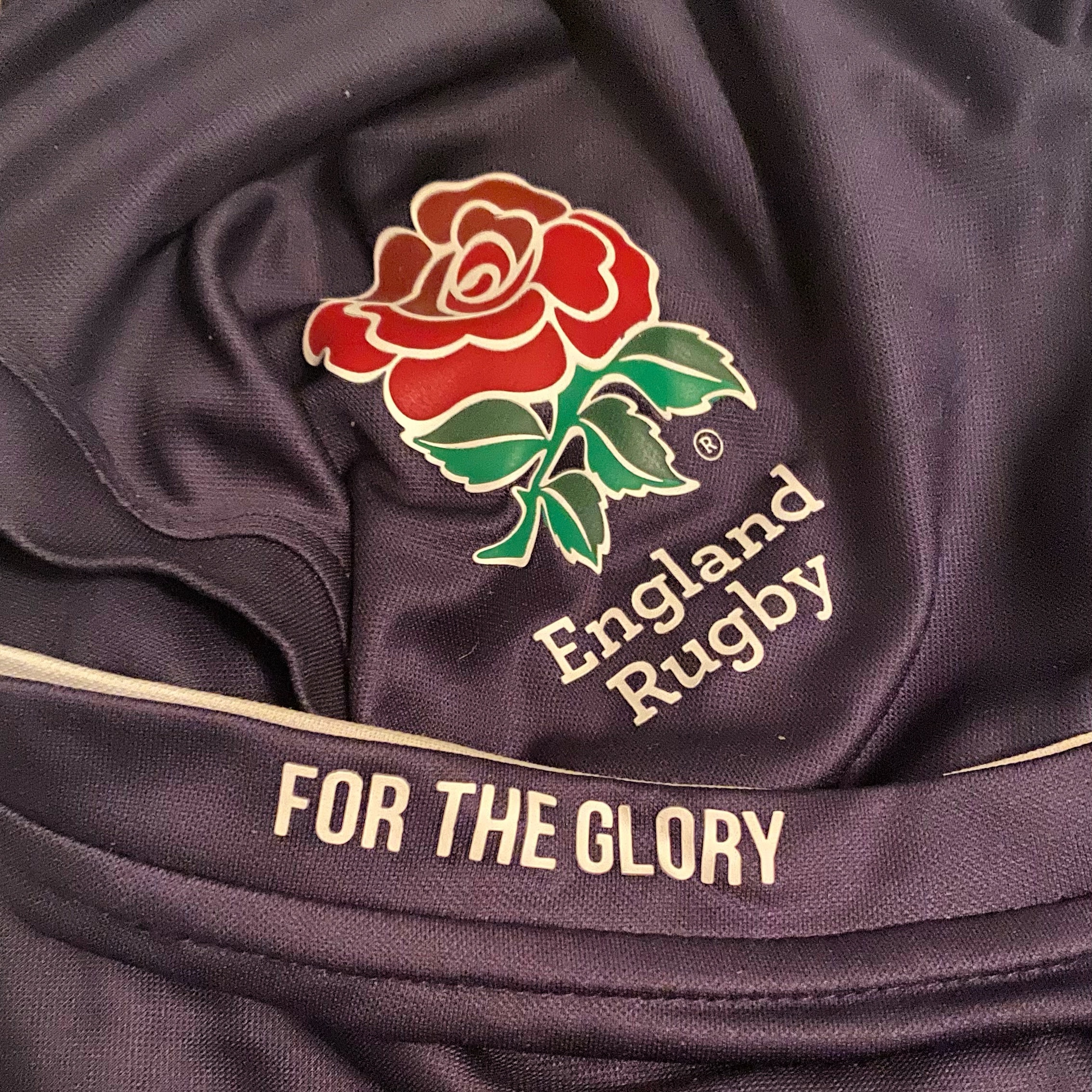 England Rugby jersey with a rose emblem and the phrase 'FOR THE GLORY' on the fabric.