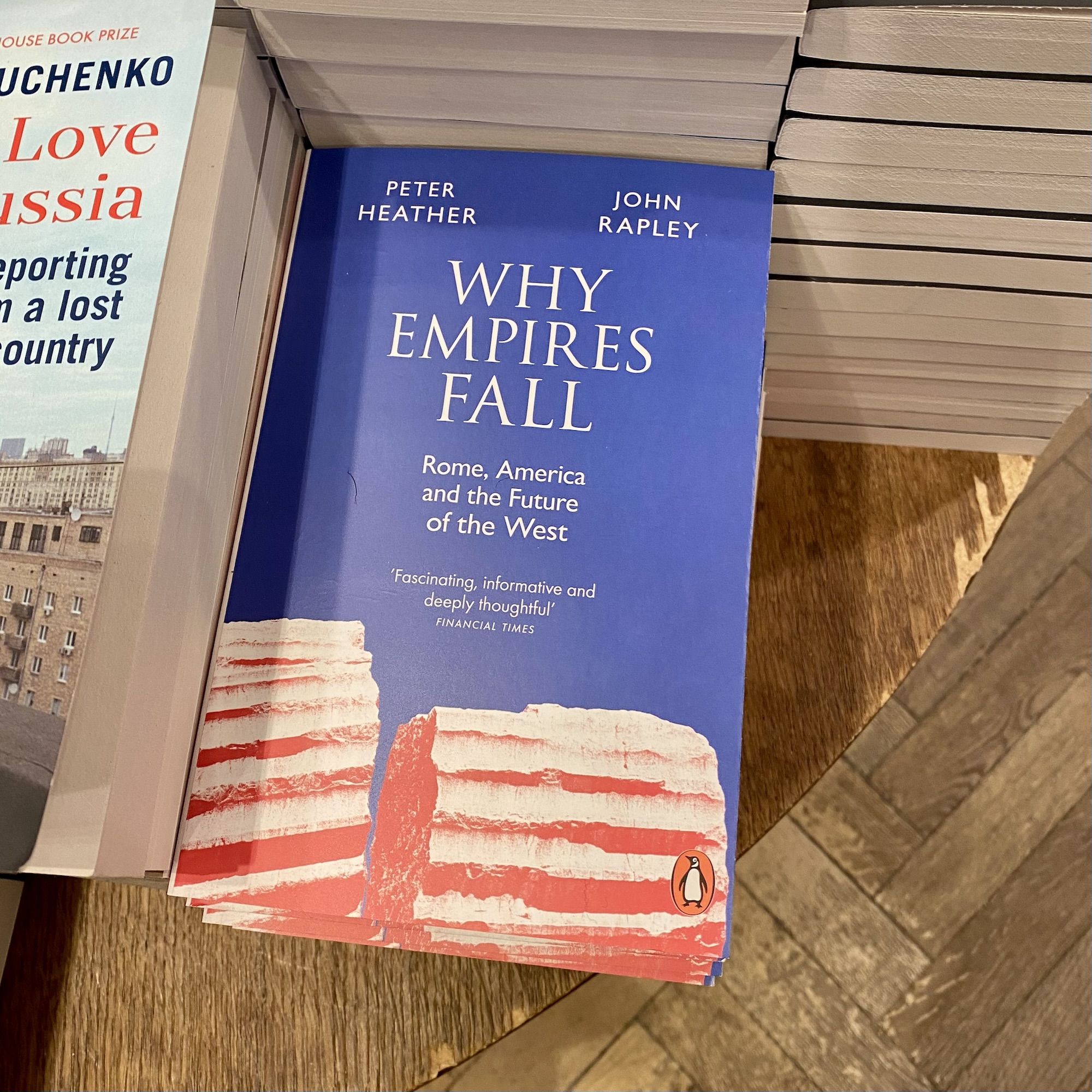 Book titled 'Why Empires Fall' by Peter Heather and John Rapley, featuring a red and white cake design on the cover.