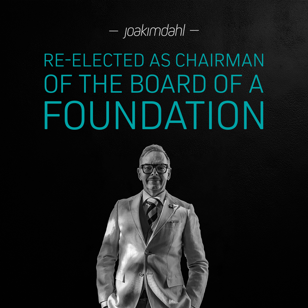 A man in a suit standing confidently with the text 'Re-elected as Chairman of the Board of a Foundation' displayed prominently.