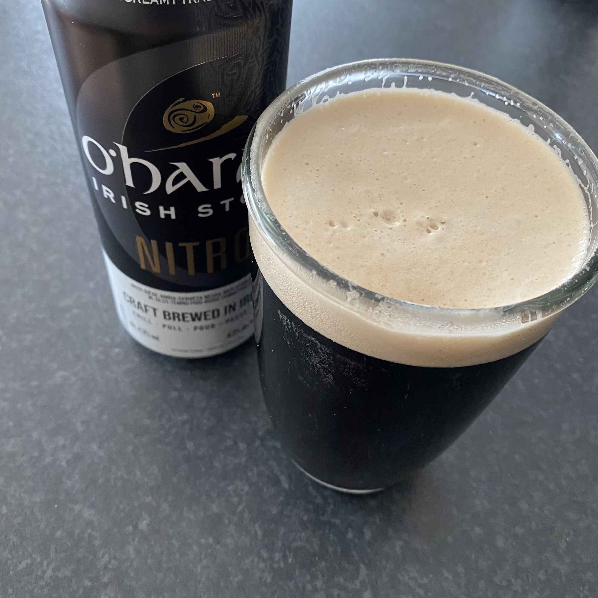 Dark stout in a glass with a creamy head beside a Nitro beer can featuring a bold label; relates to Millwall FC, Middlesbrough FC and Norwich City FC in the surrounding content.