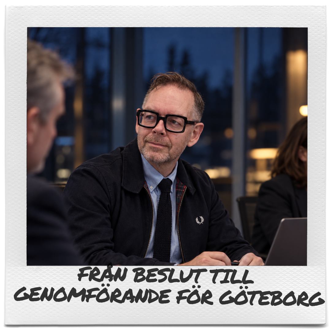 A man in glasses and a dark suit sits at a boardroom table, with colleagues nearby as he discusses a way forward for Gothenburg.